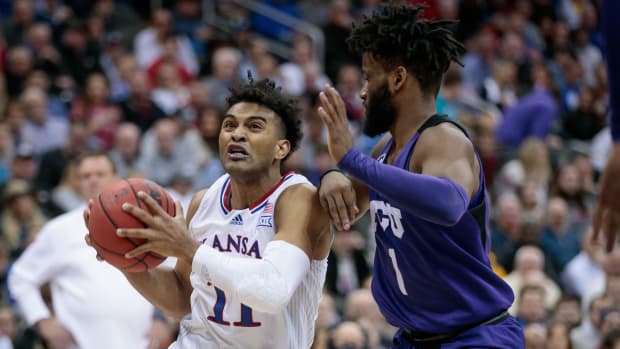 Mar 11, 2022; Kansas City, MO, USA; Kansas Jayhawks guard Remy Martin (11) drives around TCU Horned Frogs guard Mike Miles (1) during the second half at T-Mobile Center. Mandatory Credit: William Purnell-USA TODAY Sports